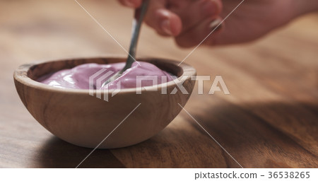 young female hand eating blueberry yogurt with young female hand eating blueberry yogurt with 36538265