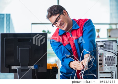 Computer repairman working on repairing computer Computer repairman working on repairing computer 36538511