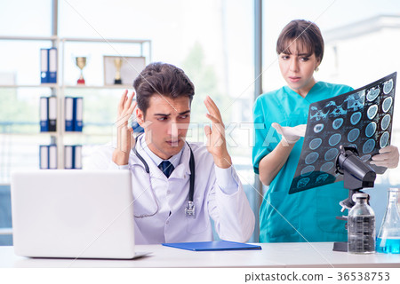 Two doctors discussing x-ray MRI image in hospital 36538753