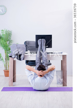 Businessman doing sports in office during break 36539739