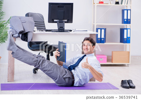 Businessman doing sports in office during break Businessman doing sports in office during break 36539741