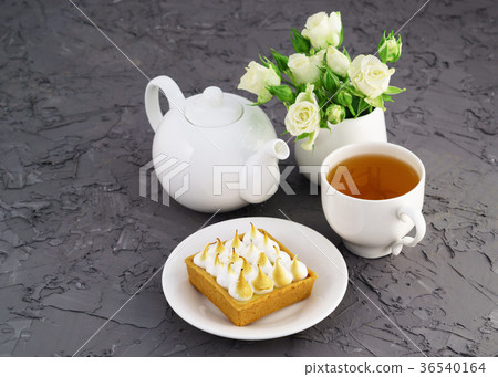 Lemon meringue pie, cup of tea, white roses Lemon meringue pie, cup of tea, white roses 36540164