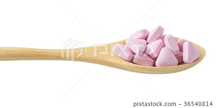 Wooden Spoon Full of Pink Vitamins on White 36540814