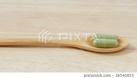 Wooden Spoon with Two Hebal Capsule Pills 36540855