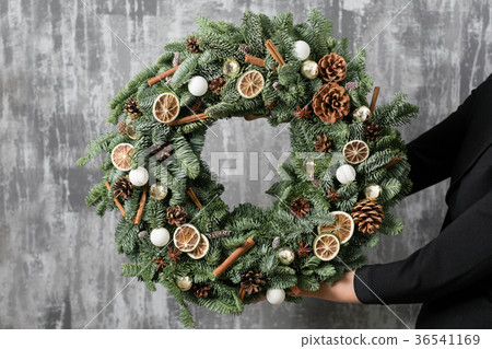 Beautiful Christmas wreath in woman hands Beautiful Christmas wreath in woman hands 36541169
