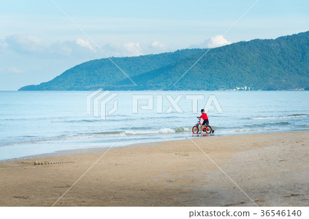 kid boy driving bicycle in the beach 36546140