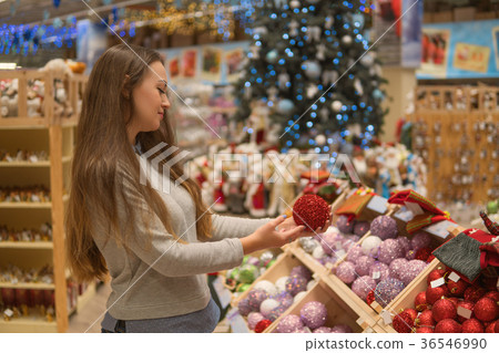 customer girl choosing gifts for Christmas and New 36546990