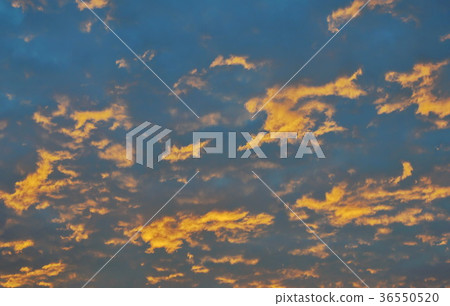 orange cloud spreading on sky in morning 36550520