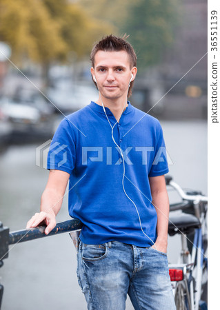 Young happy man listening to music background of Young happy man listening to music background of 36551139