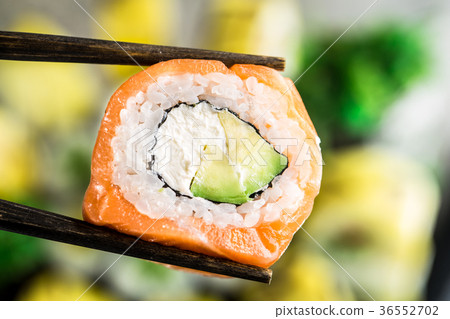 Chopsticks hold philadelphia roll Chopsticks hold philadelphia roll 36552702