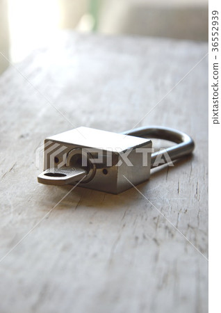 padlock unlocked on wooden board 36552939