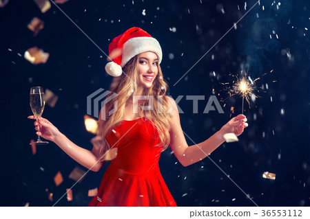 Charming woman celebrating Christmas in red dress Charming woman celebrating Christmas in red dress 36553112