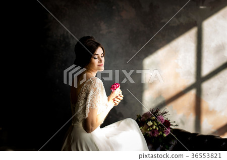 Bride in white dress sitting on chair Bride in white dress sitting on chair 36553821