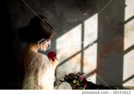 Bride in white dress sitting on chair 36553822