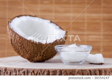organic coconut oil in a glass bowl and coconut on 36554147