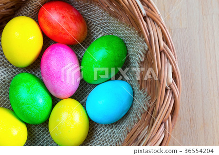 Colored decorated Easter eggs in basket Colored decorated Easter eggs in basket 36554204