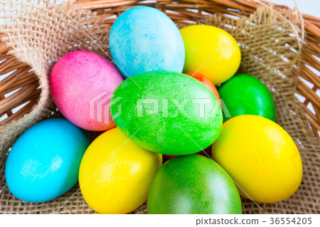 Colored decorated Easter eggs in basket Colored decorated Easter eggs in basket 36554205