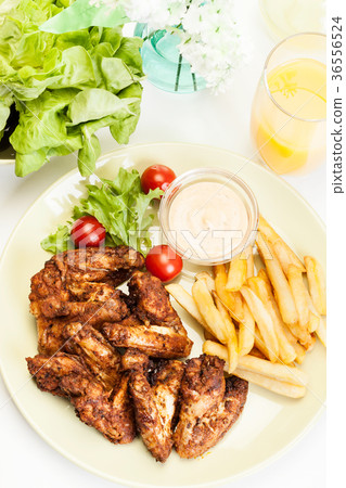 Chicken wings with fries french and spicy sauce Chicken wings with fries french and spicy sauce 36556524