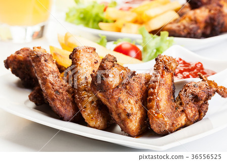 Chicken wings with fries french and spicy sauce 36556525