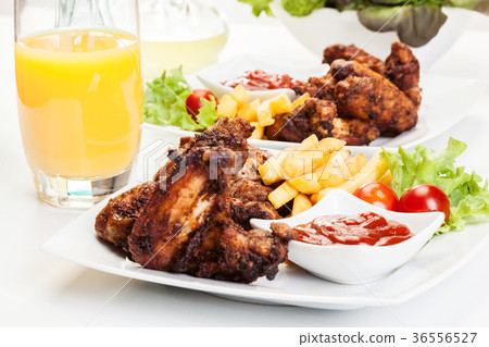 Chicken wings with fries french and spicy sauce Chicken wings with fries french and spicy sauce 36556527