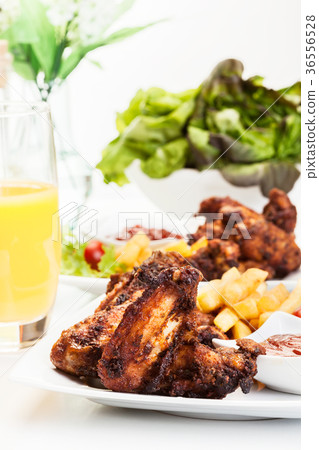 Chicken wings with fries french and spicy sauce Chicken wings with fries french and spicy sauce 36556528
