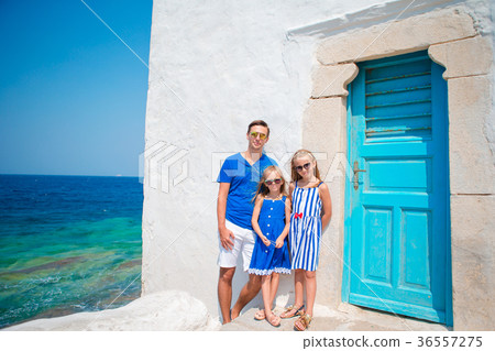 Father and kids in Mykonos town in Greece Father and kids in Mykonos town in Greece 36557275