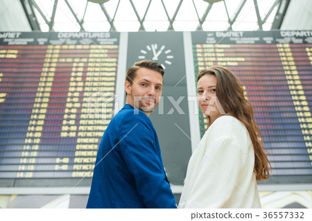 Young couple in international airport looking at Young couple in international airport looking at 36557332