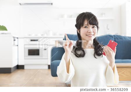 A woman watching a smartphone A woman watching a smartphone 36558209