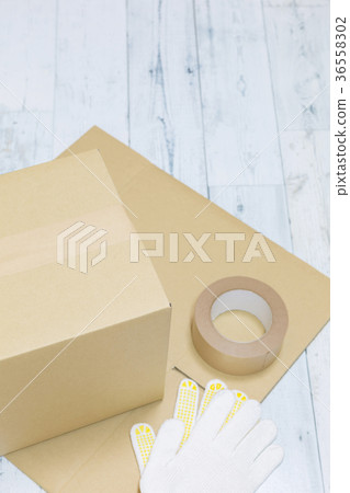 Cardboard box and craft tape and gloves Cardboard box and craft tape and gloves 36558302