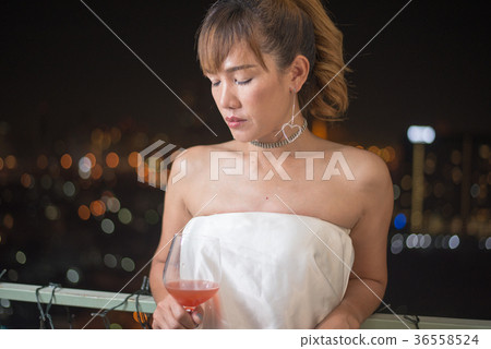 lonely asian woman with red cocktail 36558524