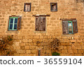 Old wooden window on brown brick wall. 36559104