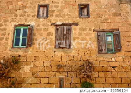 Old wooden window on brown brick wall. Old wooden window on brown brick wall. 36559104