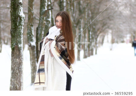Young beautiful girl in winter snowy day 36559295