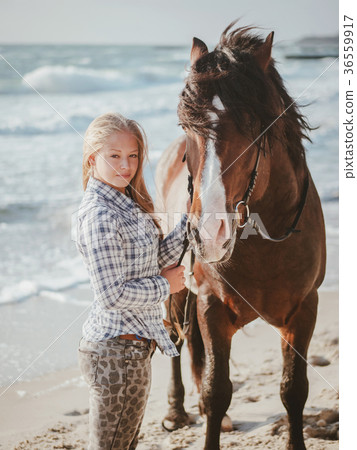 Beautiful fair-haired girl in armor with a horse Beautiful fair-haired girl in armor with a horse 36559917