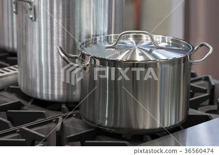 Metal stainless steel pan on a kitchen stove Metal stainless steel pan on a kitchen stove 36560474