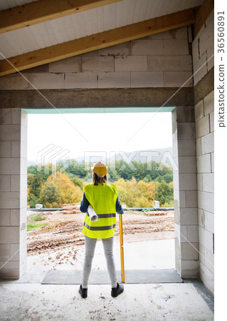Young woman worker on the building site. Young woman worker on the building site. 36560891