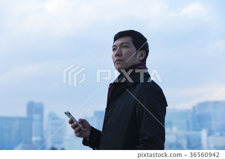 A businessman wearing a coat A businessman wearing a coat 36560942