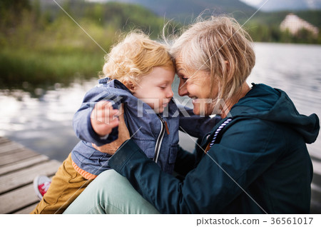 Senior woman with little boy at the lake. 36561017