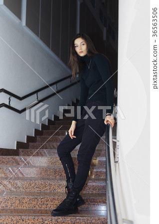 Serious girl in military trousers, rough boots Serious girl in military trousers, rough boots 36563506