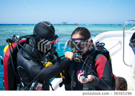 two divers in equipment on a yacht. Instruction two divers in equipment on a yacht. Instruction 36565296