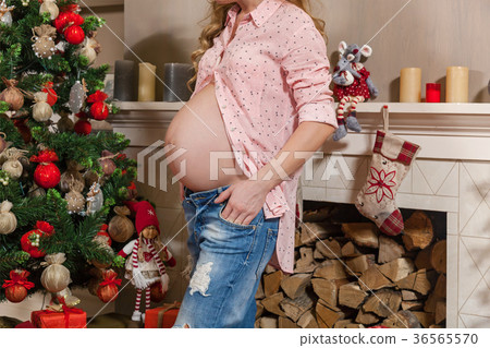 pregnant girl near Christmas tree pregnant girl near Christmas tree 36565570