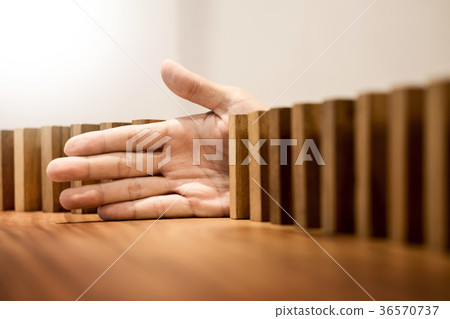 businessman hand stop dominoes continuous toppled or risk with c businessman hand stop dominoes continuous toppled or risk with c 36570737