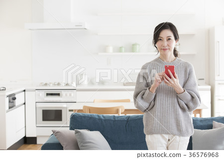 Middle woman looking at a smartphone Middle woman looking at a smartphone 36576968