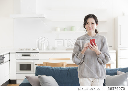 Middle woman looking at a smartphone Middle woman looking at a smartphone 36576970