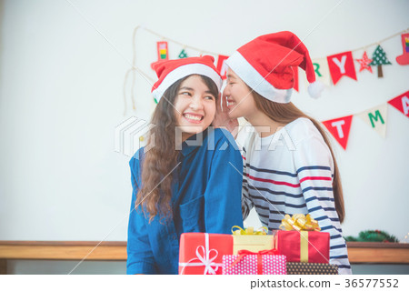 woman couple giving Christmas gift in party. 36577552