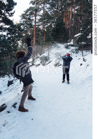 Mother and son playing with snowballs Mother and son playing with snowballs 36577557