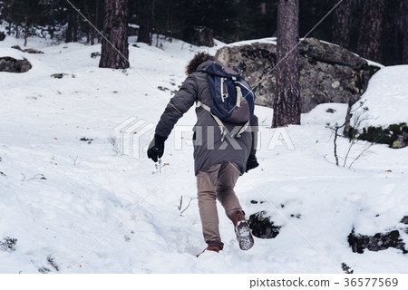 Woman walking up in the snowed mountain 36577569