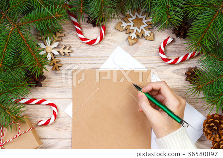 girl hand writing Christmas letter on craft paper 36580097
