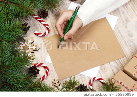 Female hands writing a letter to Santa Claus. 36580099