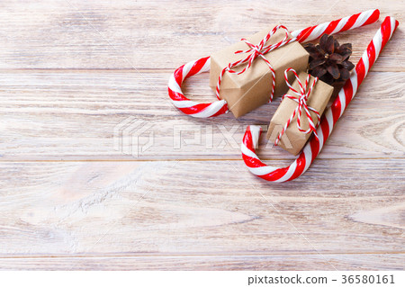 candy canes and christmas gift on wooden table 36580161